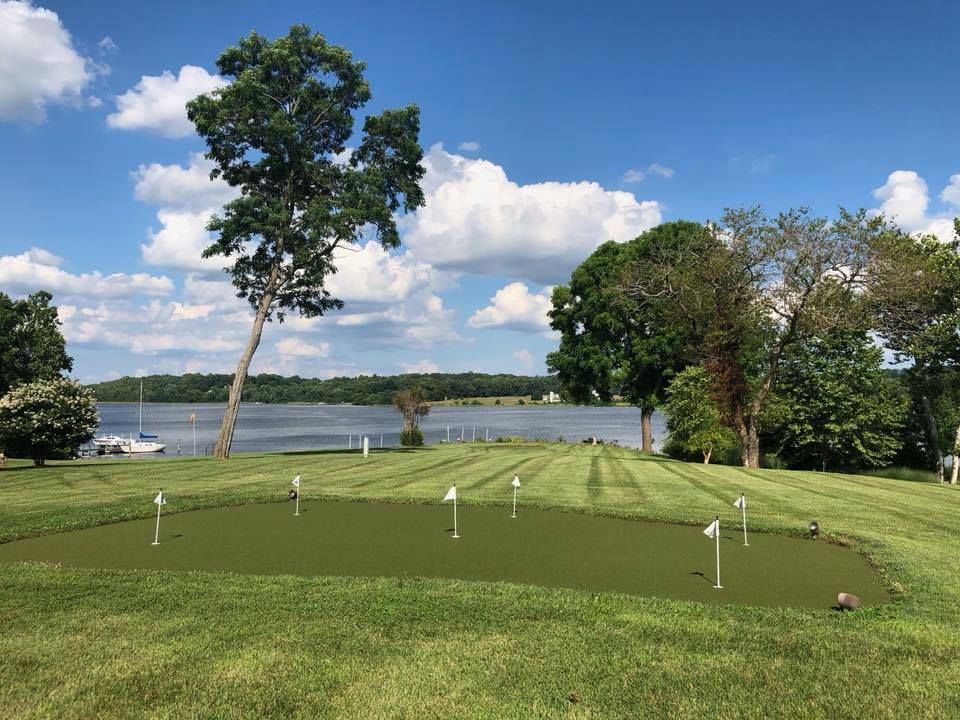 Artificial putting green by lake