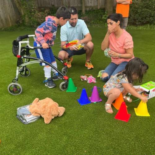 Rohan playing with his family on the artificial grass make a wish project
