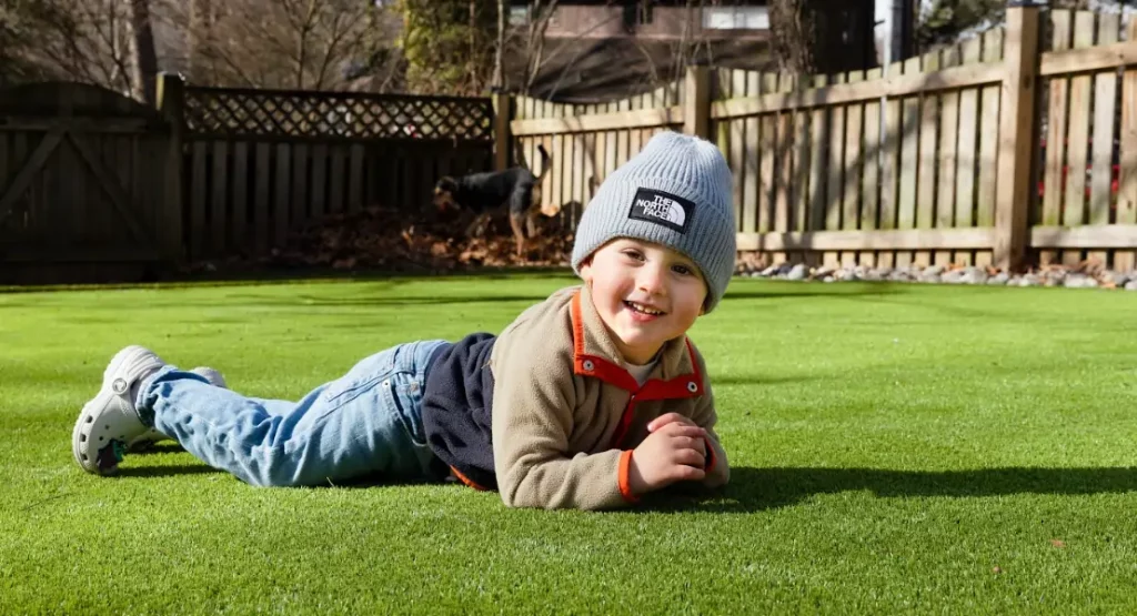 child on artificial grass lawn