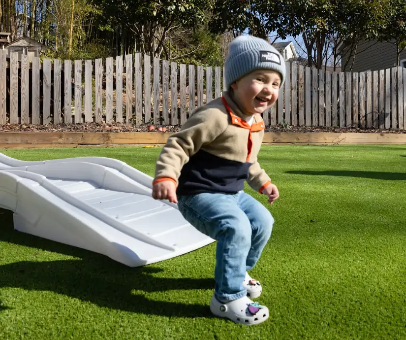 child on artificial grass lawn