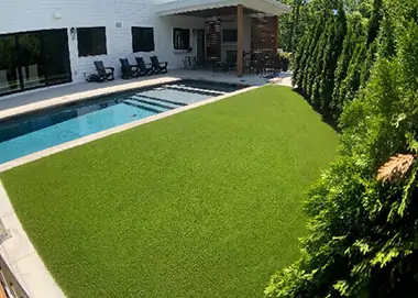 Artificial Grass Backyard pool area installed by SYNLawn